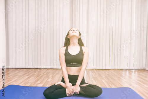 Beautiful young fit asian woman doing yoga.