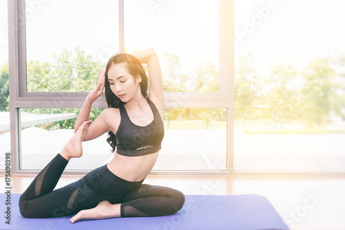 Beautiful young fit asian woman doing yoga.