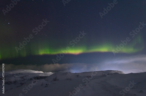 The snow covered the hills and in the sky the stars and the aurora borealis. © Moroshka