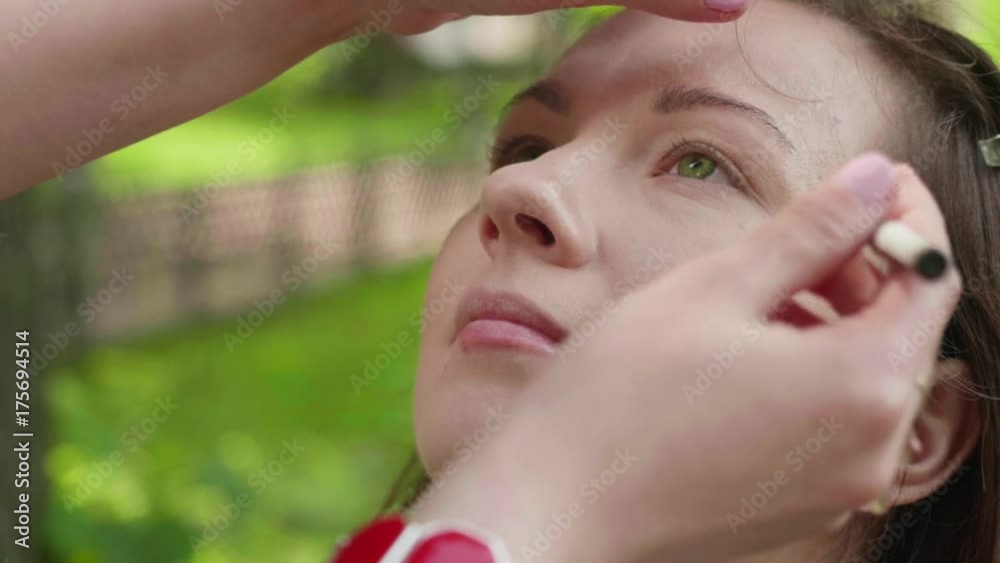 Make up artist applies eyeliner to top of lashlines before photoshoot. Slow motion Make up artist applies eyeliner to top of lashlines before photoshoot. Slow motion