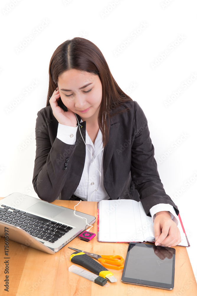 Portrait of asian business woman working on desk and use smartphone listening music. Portrait of asian business woman working on desk and use smartphone listening music.