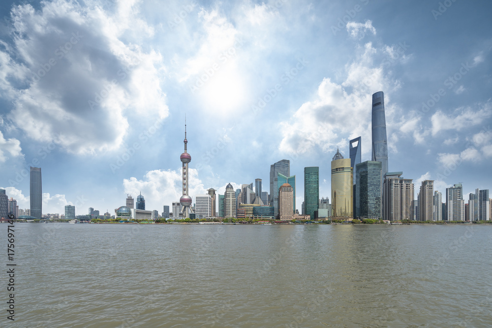 panoramic view of shanghai skyline with huangpu river under blue sky
