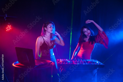 Pretty Asian female woman DJ playing music for dance.