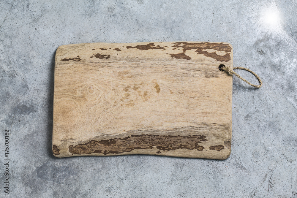 Fototapeta premium Cutting board on the cement background. Top view.
