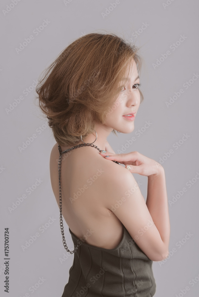Beauty portrait of elegant young asian woman, Glamour makeup, Asian model shot hair stand back in studio.