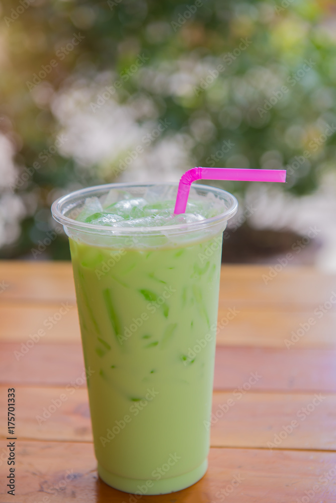 Iced green tea latte on wood table in cafe. Iced green tea latte on wood table in cafe.