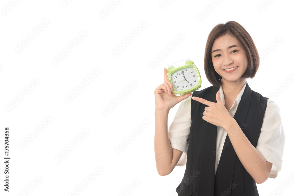 Portrait of asian woman standing and holding alarm clock on pointing at it. Business woman happy when 17.00 pm. on white background. Work out concept. Portrait of asian woman standing and holding alarm clock on pointing at it. Business woman happy when 17.00 pm. on white background. Work out concept.