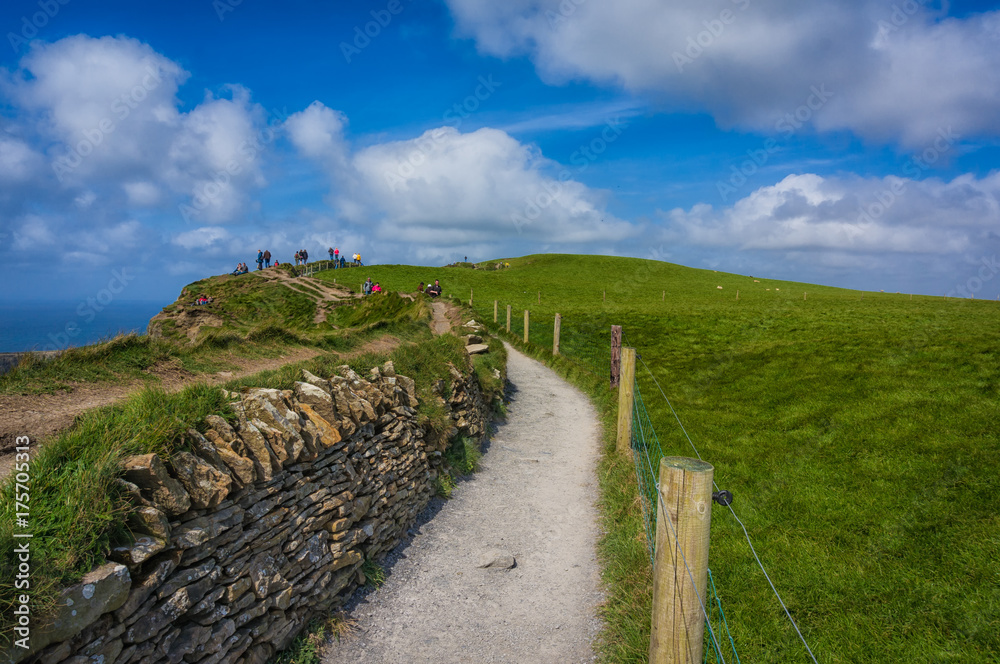 People hiking the Cliffs of Moher, County Clare