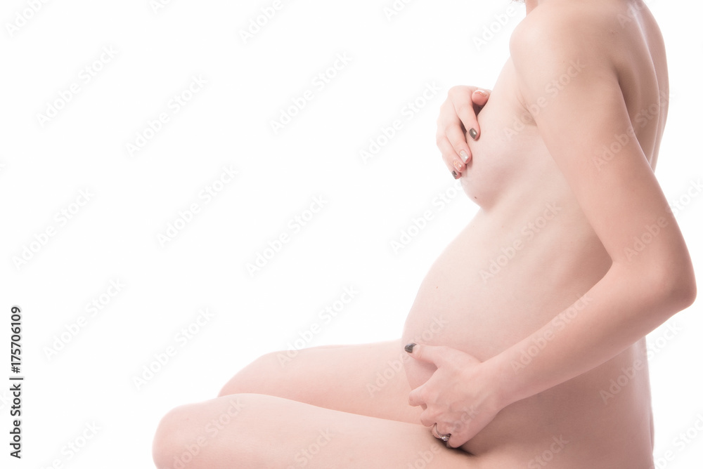 Beautiful naked body of a pregnant woman. Closeup photo.
