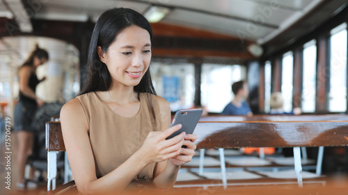 Photography Woman using cellphone on public ferry in Hong Kong