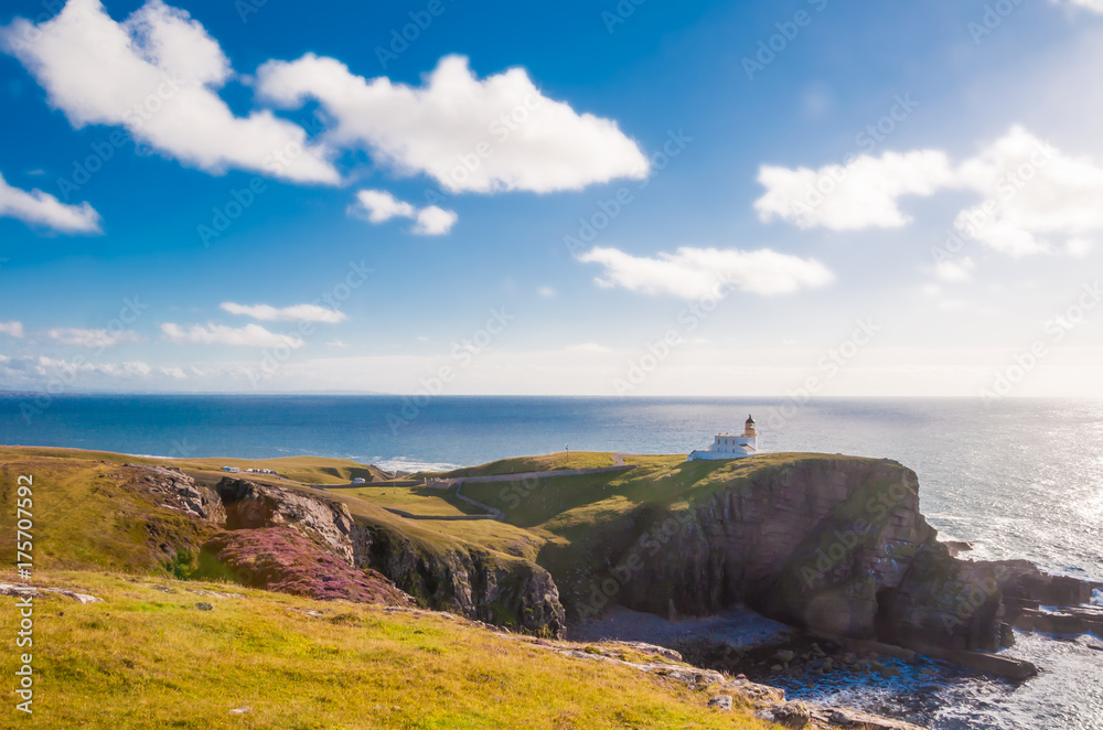 Lighthouse on a rocky coast in highlands of Scotland