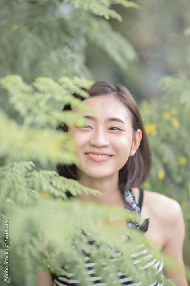Beautiful asian young woman outdoors in a forest. Pretty Thai girl in garden. Beautiful asian young woman outdoors in a forest. Pretty Thai girl in garden.