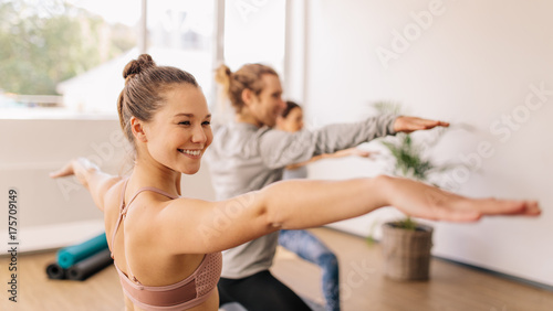 Woman practicing yoga at gym class