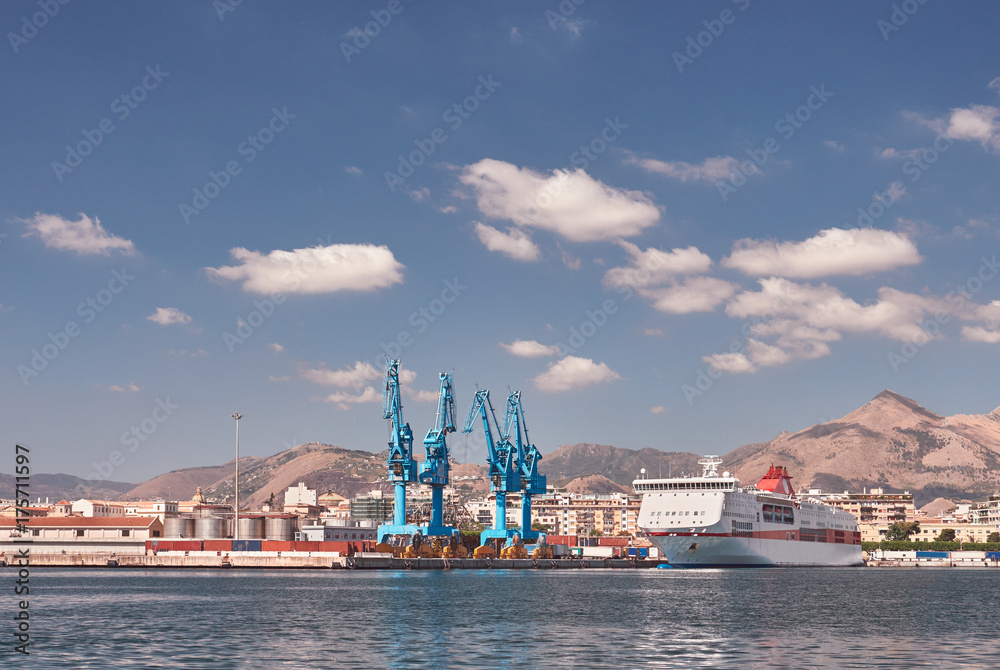 Harbor of Palermo, harbor crane, mountains in background - Sicily