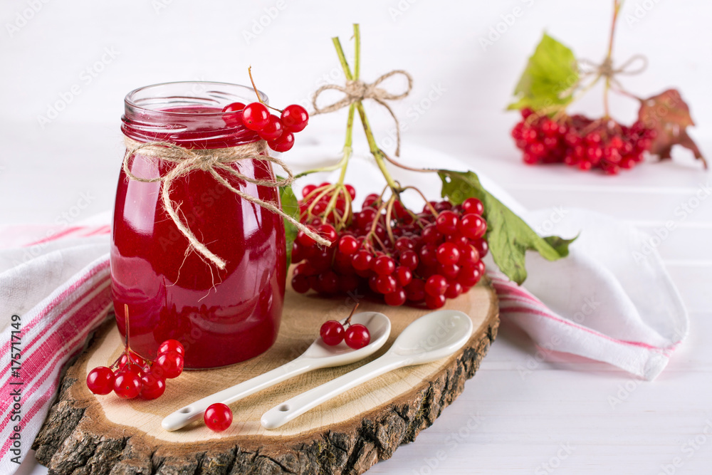 Delicious viburnum jam with fresh berries on white table. Delicious viburnum jam with fresh berries on white table.