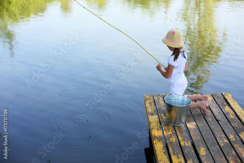 little girl fishing in river