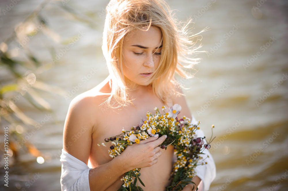 Naked beautiful and sexy blond woman with wreath in hand Naked beautiful and sexy blond woman with wreath in hand