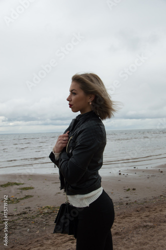 black and white, on a background of the sea and the beach, portrait of girl