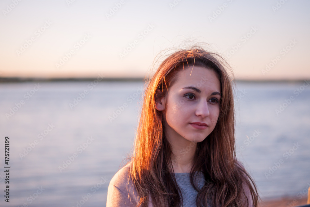 Girl at sunset at the river