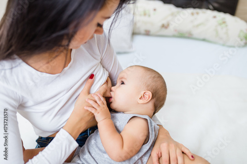 Beautiful mother brest feeding her cute little baby.