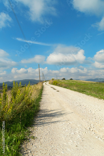 Rural landscape with country road and blue sky