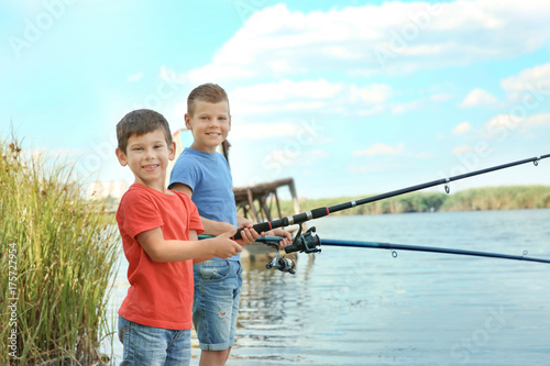 Cute children fishing on summer day