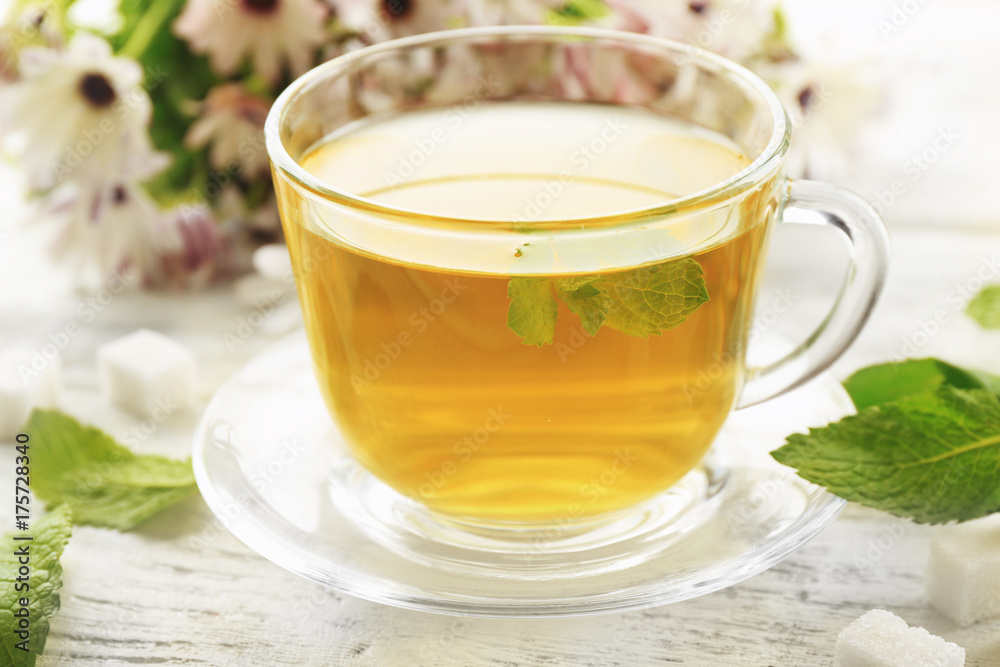 Cup of mint tea on wooden table Cup of mint tea on wooden table