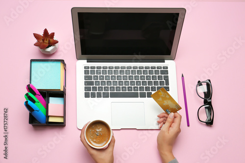 Woman using laptop and cred...