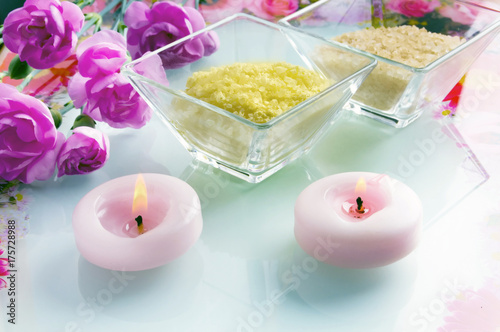 Wellness concept with candles  pink flower  bowls with bath salt in pastel coloring 