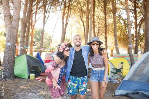 Happy friends standing together at campsite © WavebreakMediaMicro