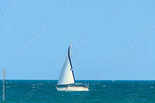 ALBENA, BULGARIA - JUNE 17, 2017: Wind boat yacht on blue Black Sea water near beach