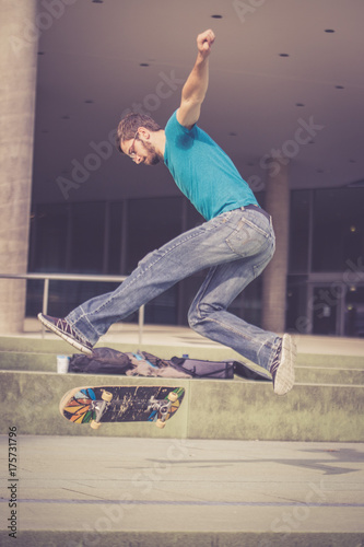 Junger Mann mit Skateboard, Stunt, Innenstadt photo