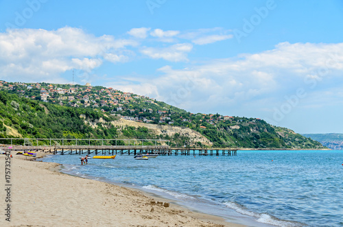 ALBENA  BULGARIA - JUNE 16  2017  The Black Sea shore  green hills with houses  blue clouds sky. City Balchik coast