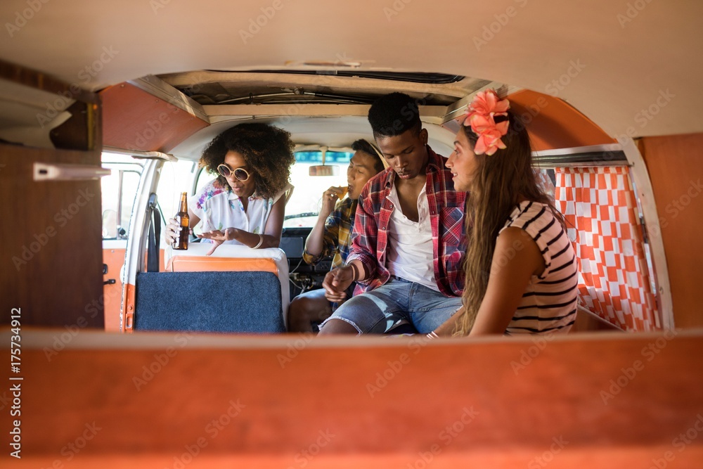 Young friends sitting in camper van