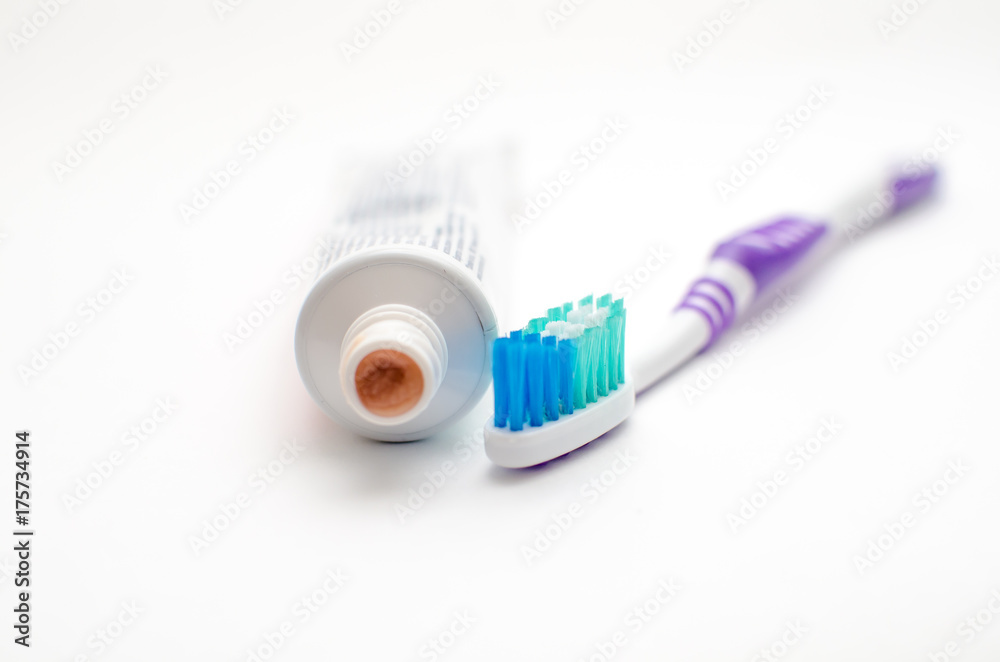 On a white background lies toothpaste and brush On a white background lies toothpaste and brush