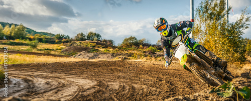 Canvas Print Extreme Motocross MX Rider riding on dirt track