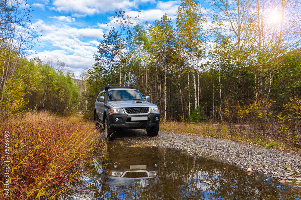Japanese off road vehicle in autumn forest Japanese off road vehicle in autumn forest