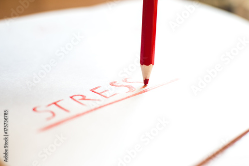 Red pastel pencil to write the word-stress underlined. photo