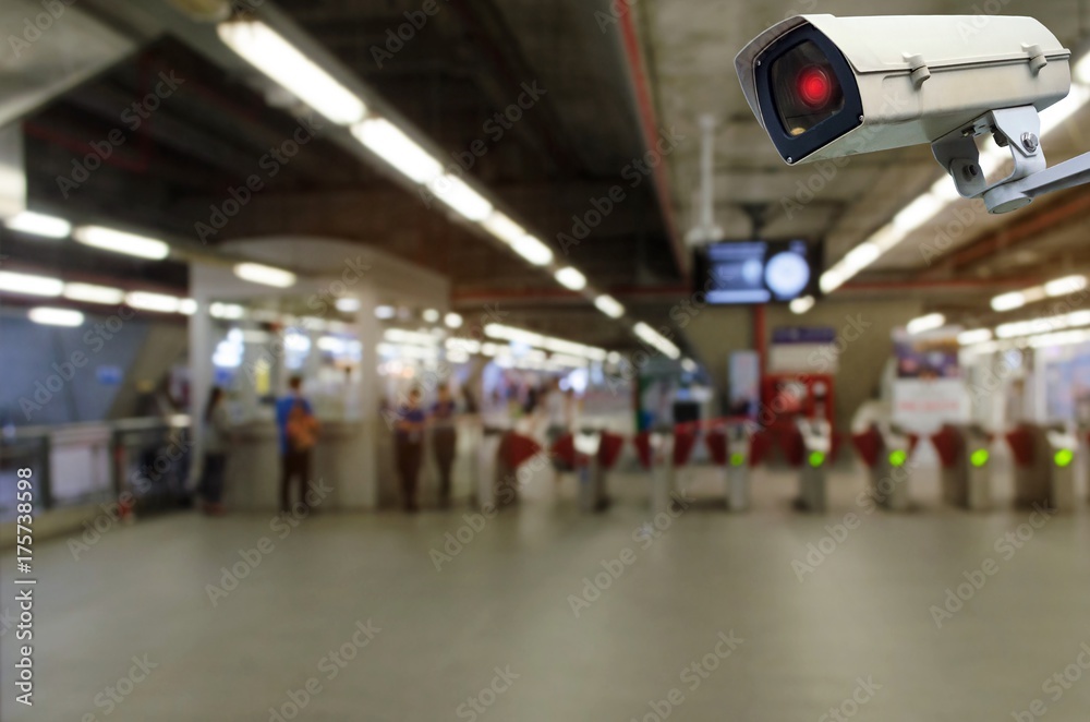 CCTV security indoor camera system operating with blurred image of entrance of subway or railway at train station, transportation, surveillance security and safety technology concept CCTV security indoor camera system operating with blurred image of entrance of subway or railway at train station, transportation, surveillance security and safety technology concept