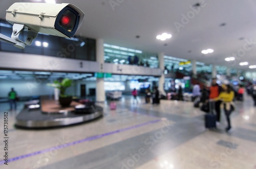 CCTV security indoor camera system operating with blurred image of passenger walking in airport terminal, people, transportation, surveillance security and safety technology concept © Vittaya_25