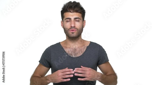 slow motion calm skinny bearded man meditating taking deep breath gesturing while inhaling exhaling with closed eyes over white background. Concept of emotions