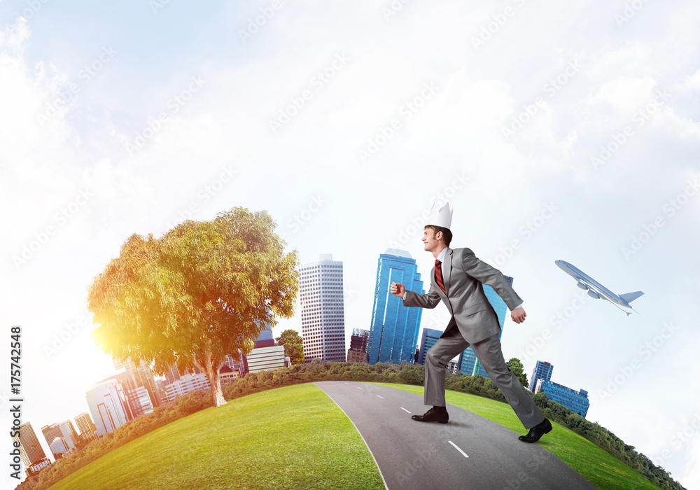 King businessman in elegant suit running on green globe with modern cityscape