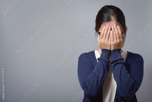 Stressed Asian glasses woman.