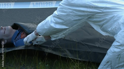 coroner zip up the body bag corpse inside photo