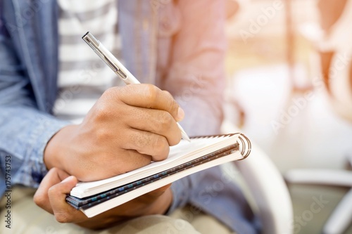 фотографія close up hand people are writing Record Lecture notepad  into the book