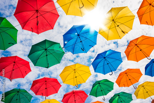Many colorful umbrellas hanging in the sky photo