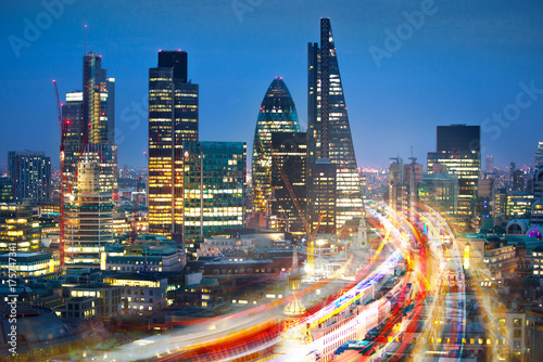 City of London at sunset and traffic blur lights on busy roads. Technology, transformation and innovation idea. 