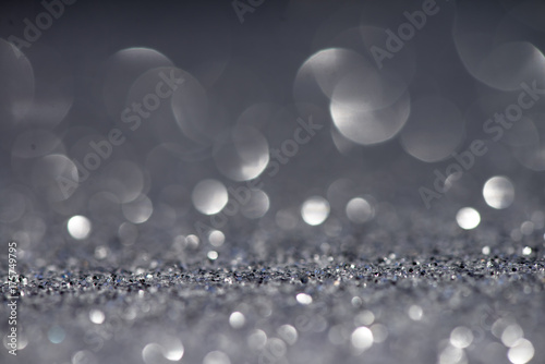 Silver white glittering Christmas lights. Blurred abstract festive background