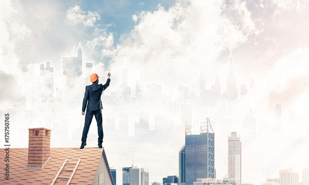 Man architect draw silhouette of modern city on blue sky. Mixed Man architect draw silhouette of modern city on blue sky. Mixed