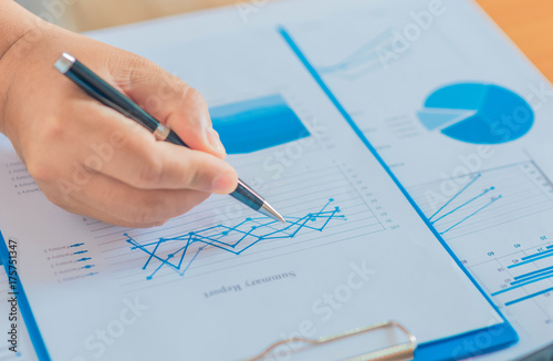 Businessman working with sheet analysis charts.